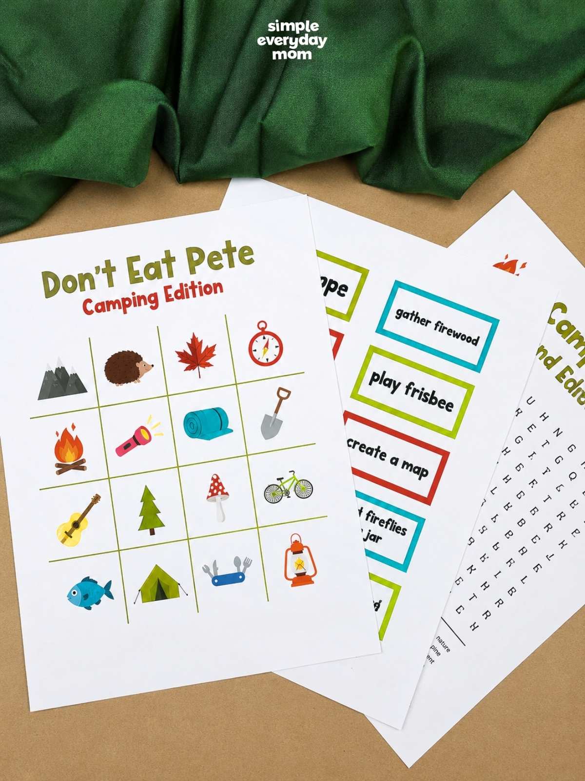 Three printable camping game pages are fanned out, featuring a "Don't Eat Pete" game board, camping charades cards, and a camping word search.
