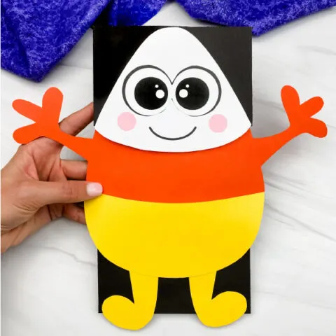 hand holding candy corn puppet craft