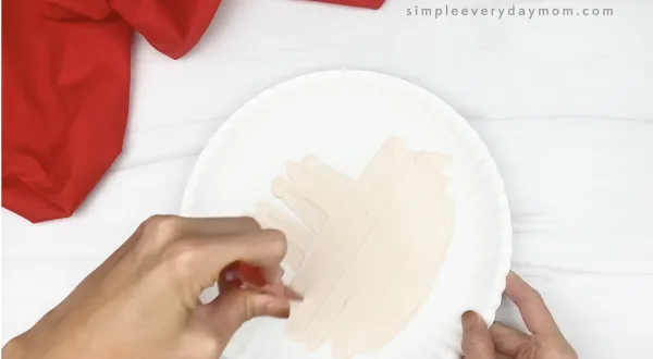 hand painting white paper plate cream