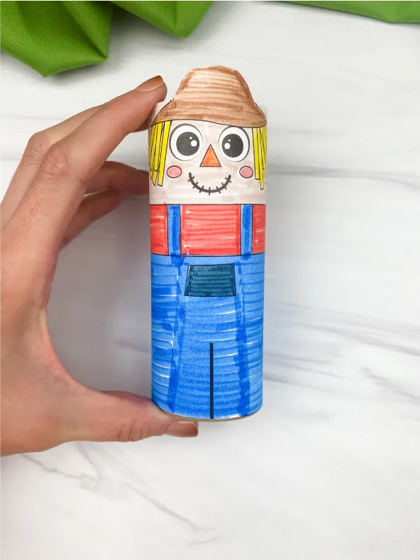 hand holding cardboard tube scarecrow craft