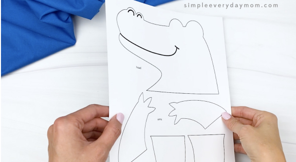 hand holding paper bag alligator craft template