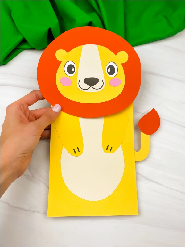 hand holding paper bag lion craft