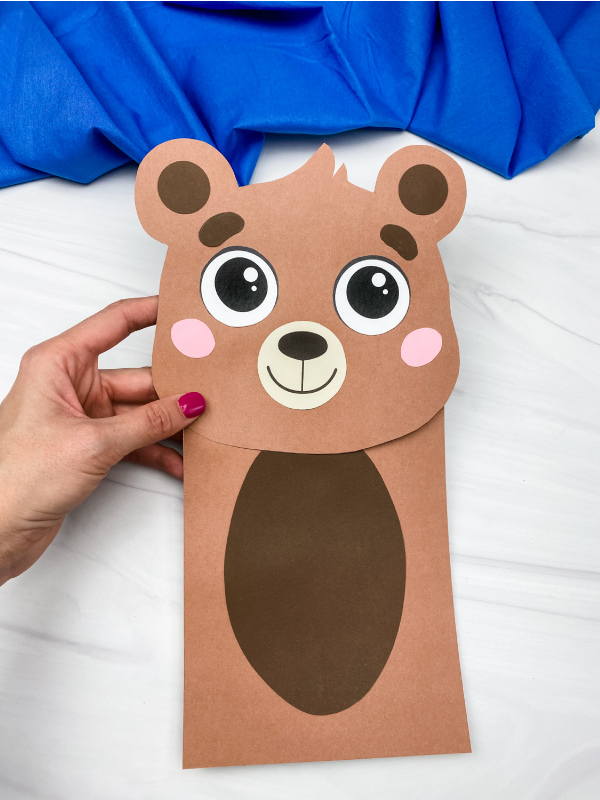 hand holding brown bear paper bag puppet craft