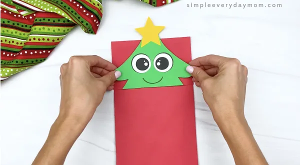 hand gluing top to paper bag Christmas tree craft