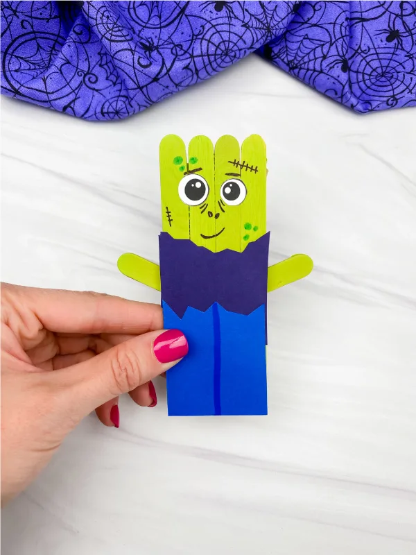 hand holding zombie popsicle stick