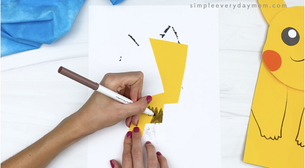 hand drawing details on paper bag Pikachu tail