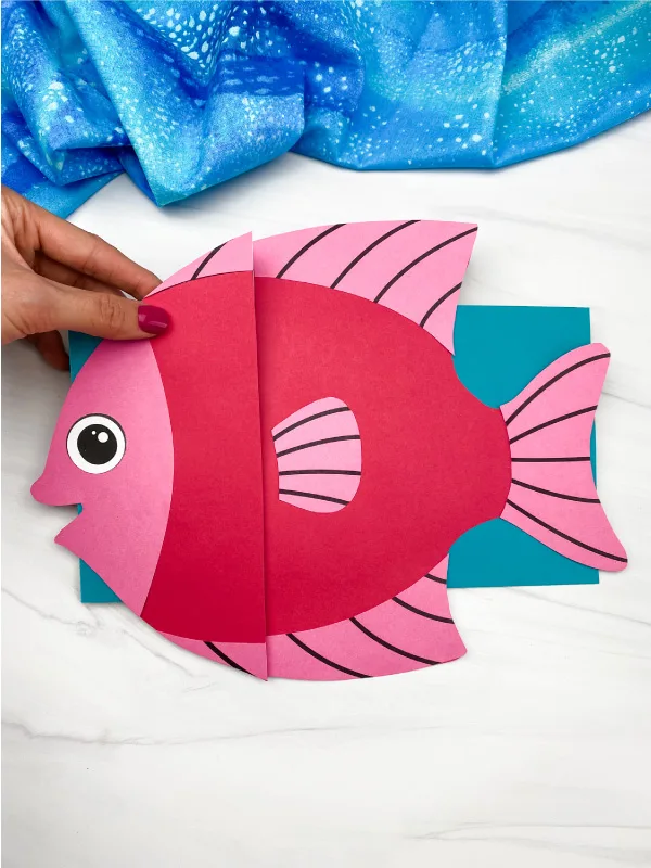 hand holding fish paper bag puppet craft