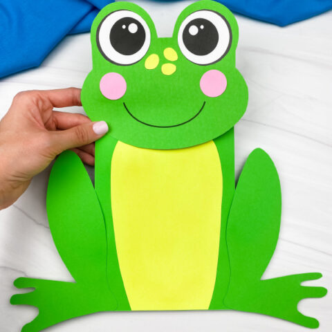 hand holding paper bag frog craft