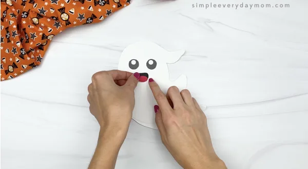 hand gluing mouth to paper plate ghost craft