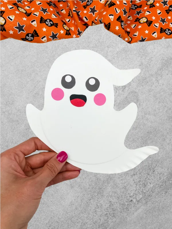 hand holding paper plate ghost