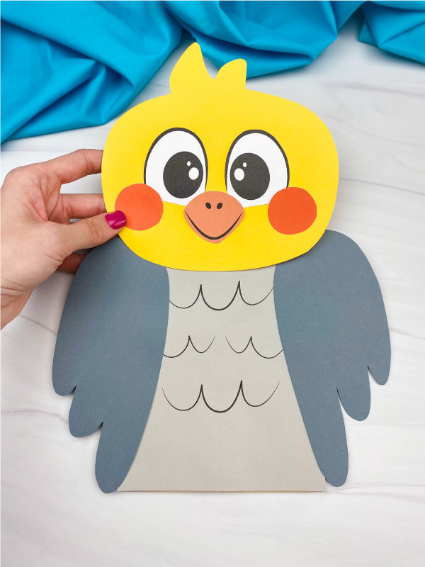 hand holding paper bag bird craft