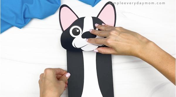 hand gluing body to paper bag dog craft