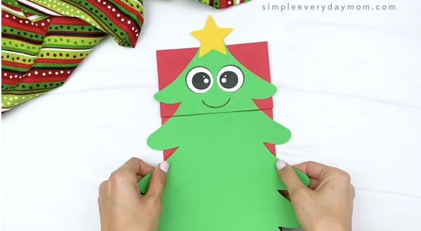 hand gluing base to paper bag Christmas tree craft