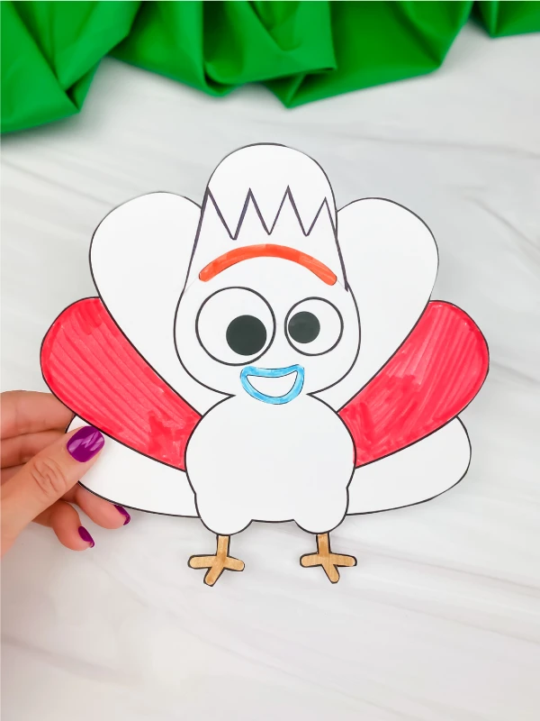 hand holding Forky turkey in disguise