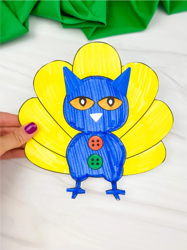 hand holding Pete the cat turkey in disguise