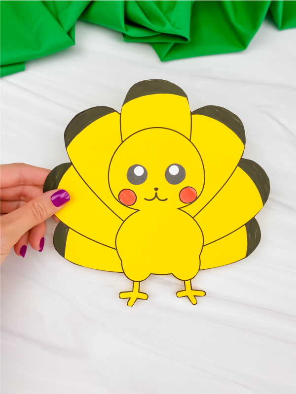 hand holding Pikachu turkey in disguise
