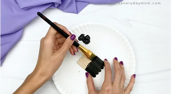 hand painting popsicle sticks black