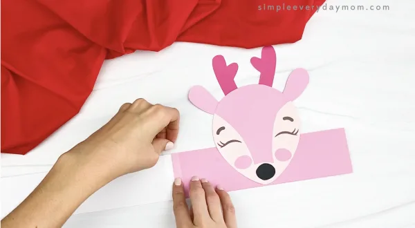 hand taping extender to pink reindeer headband