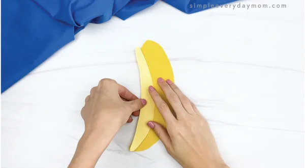 hand gluing highlight onto paper banana craft