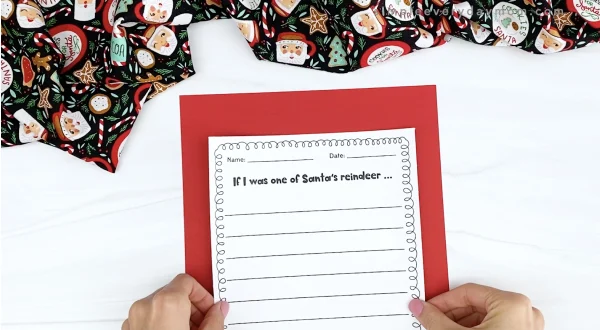 hand gluing writing prompt to reindeer craftivity