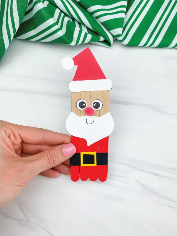 hand holding popsicle stick Santa craft