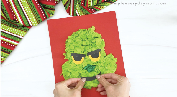 hand gluing mouth to tissue paper grinch