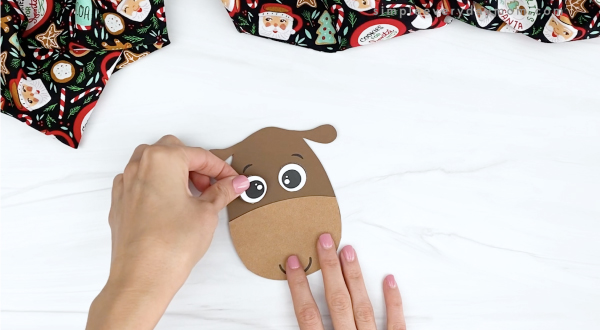 hand gluing eyes to reindeer craftivity