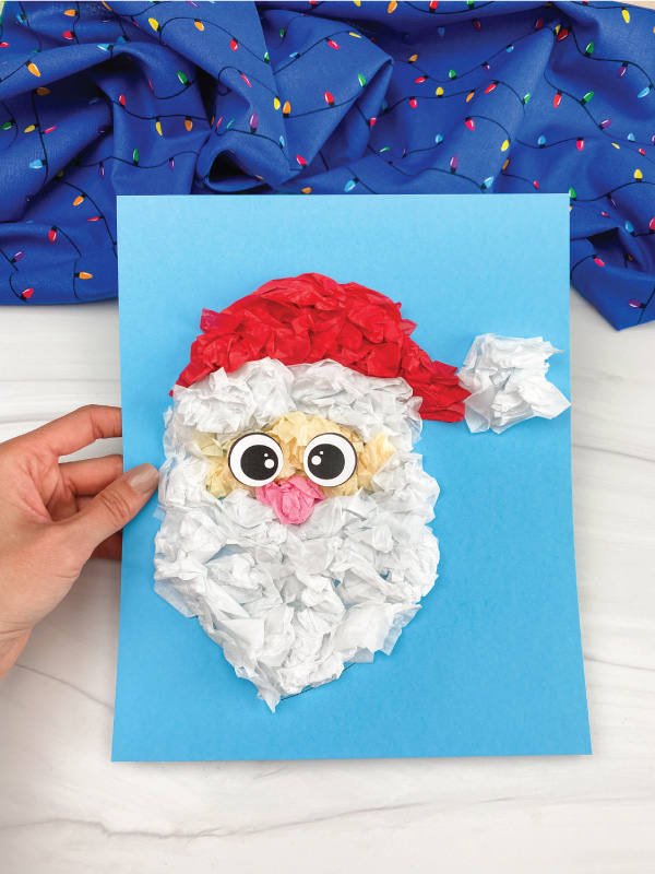 hand holding tissue paper Santa craft
