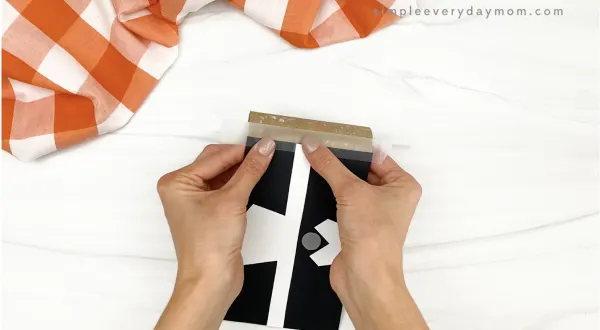 hand taping body to toilet paper roll pilgrim