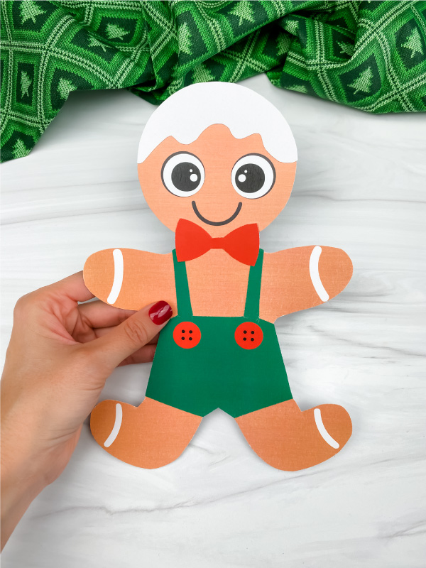 hand holding printable gingerbread man craft