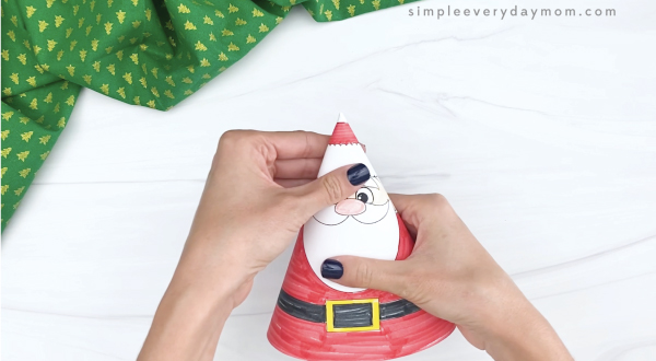 hand flattening Santa cone craft