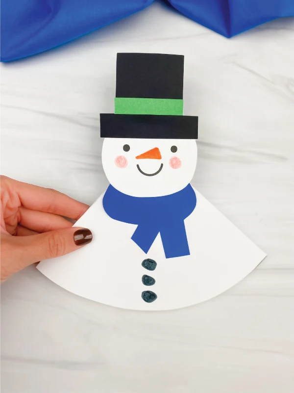 hand holding rocking snowman craft