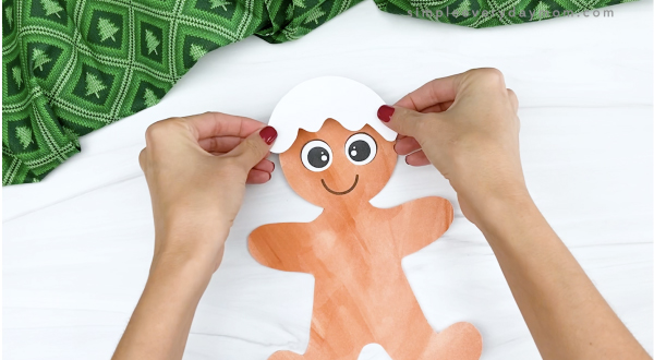 hand gluing icing hair to printable gingerbread craft