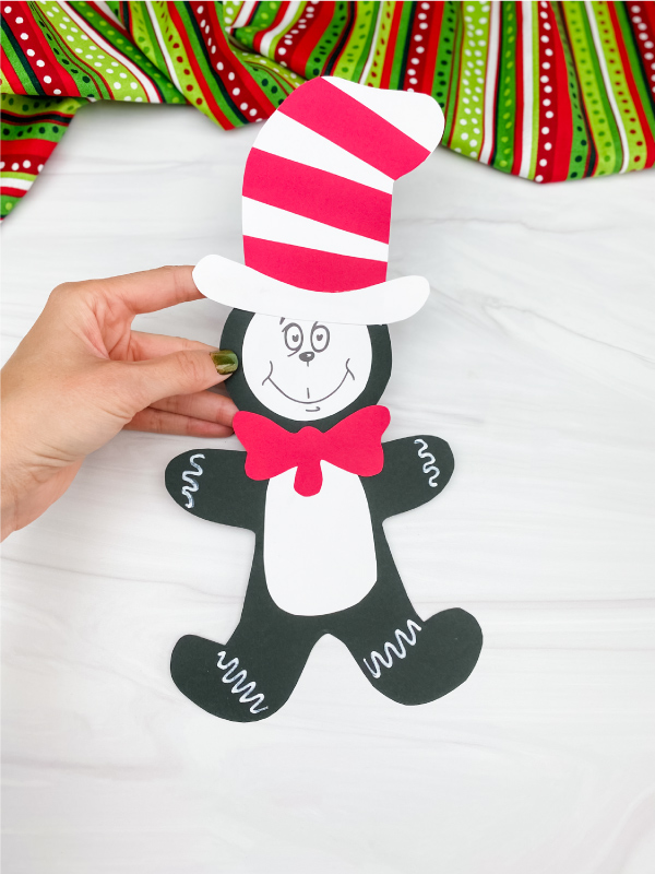 hand holding cat in the hat gingerbread man craft
