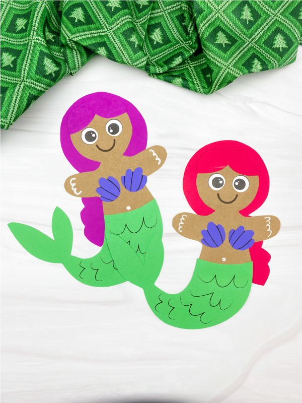 2 hand gluing tail onto mermaid gingerbread man crafts