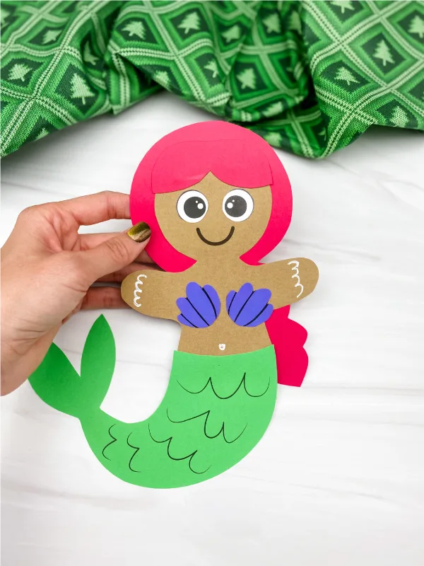 hand holding mermaid gingerbread man craft