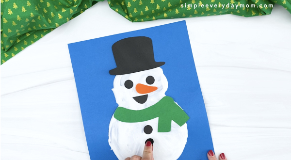 hand gluing buttons to puffy paint snowman