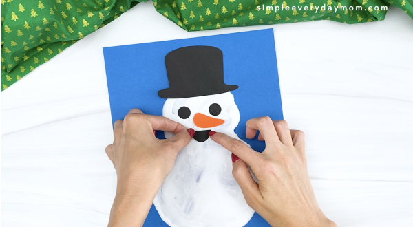 hand gluing mouth to puffy paint snowman
