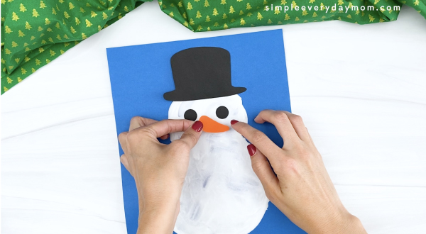 hand gluing nose to puffy paint snowman