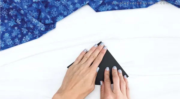 hand folding half circle of black paper