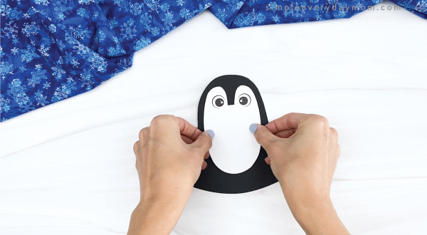 hand gluing belly to rocking penguin craft