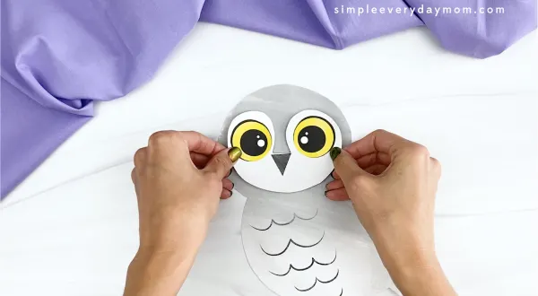 hand gluing face to printable snowy owl craft