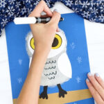 hand drawing snowflakes onto snowy owl craft