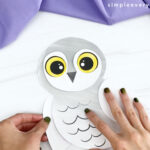 hand gluing left wing to printable snowy owl craft