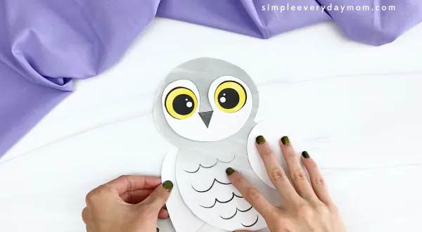 hand gluing left wing to printable snowy owl craft