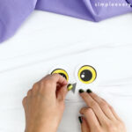 hand gluing beak to printable snowy owl craft