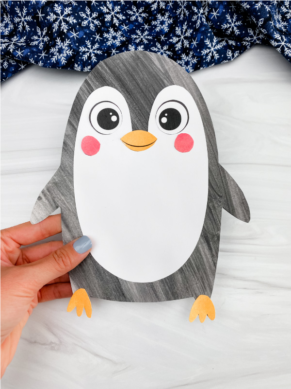 hand holding printable penguin craft