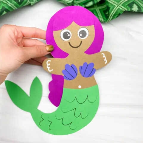 hand holding mermaid gingerbread man craft
