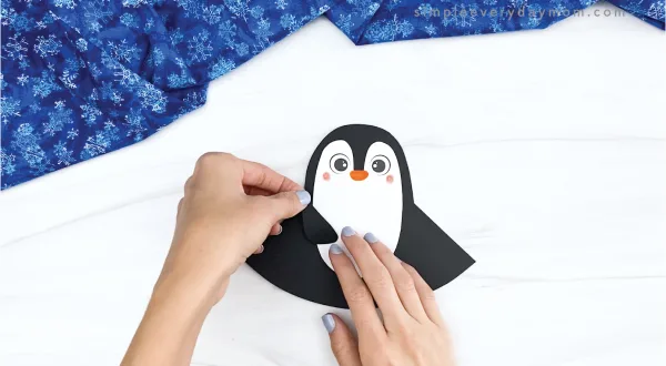 hand gluing flipper to rocking penguin craft
