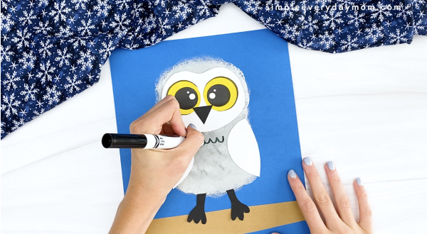 hand drawing belly feathers onto snowy owl craft